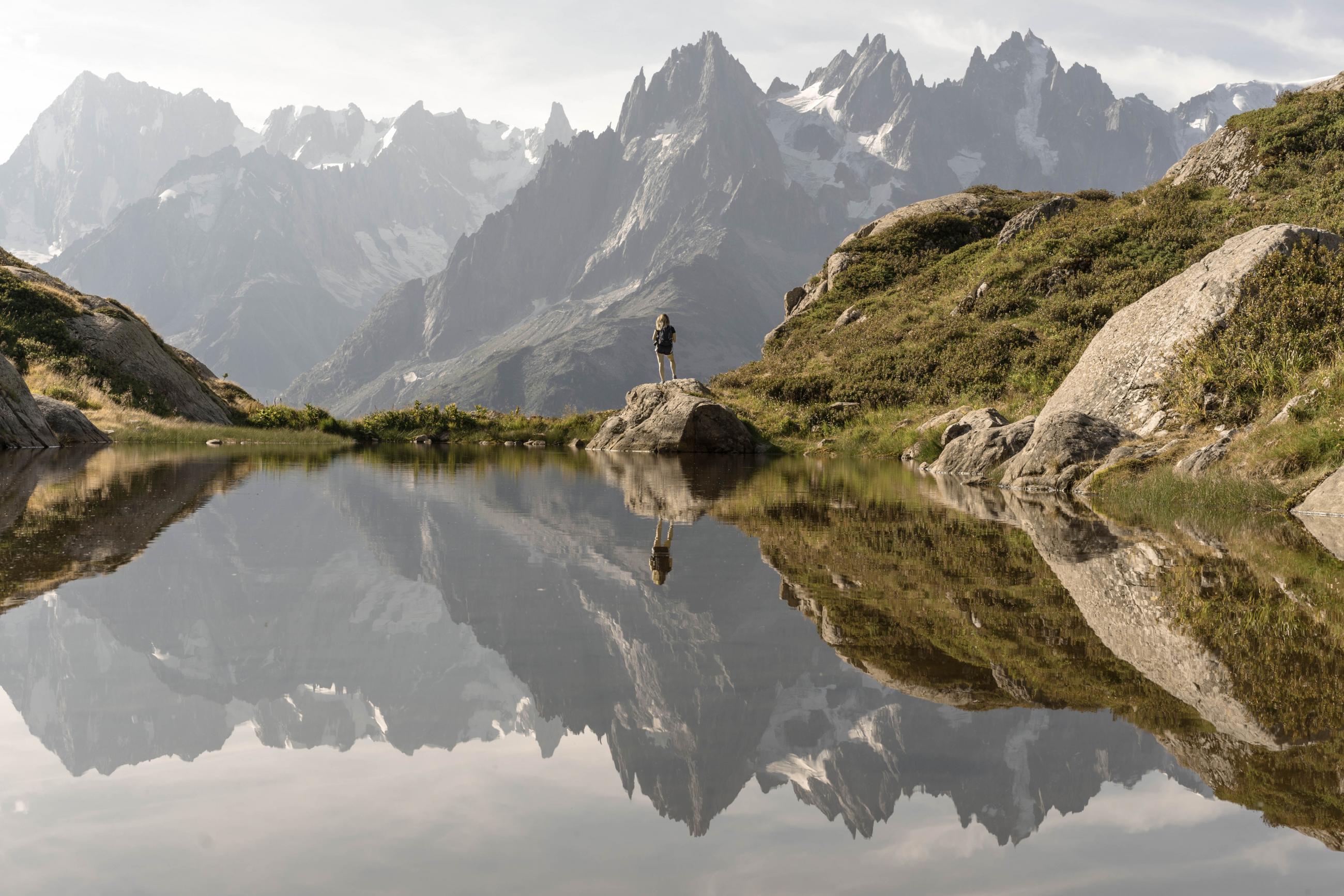 Mountain view with woman standing in distance